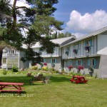 Front yard Carlson's Lodge lawn chairs picnic tables benches sunny summer relaxation
